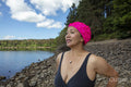 Woman in swimsuit standing on rocky lakeshore, Yorkshire, UK