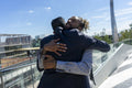 Two businessmen hugging in business district
