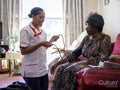 Nurse taking care of elderly woman, measuring blood pressure