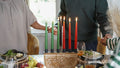 Family with daughter holding hands over Kwanzaa meal