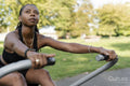 Young woman exercising in outdoor gym