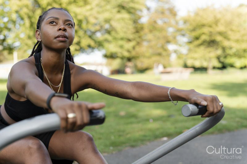 Young woman exercising in outdoor gym