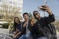 Group of friends taking selfie on campus
