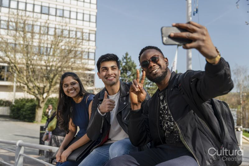 Group of friends taking selfie on campus