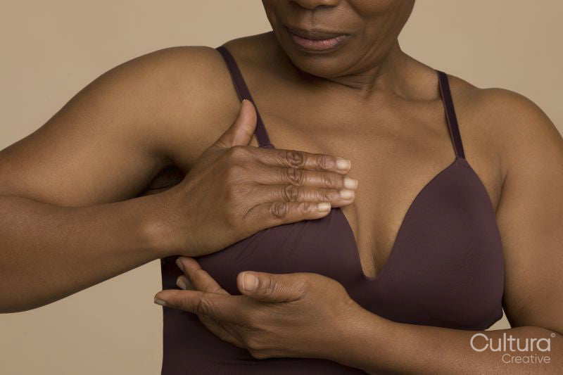 Close-up of woman doing breast cancer self check