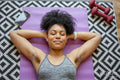 Young woman lying on exercise mat