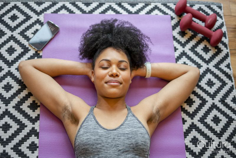 Young woman lying on exercise mat
