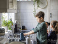 Children washing hands in kitchen sink