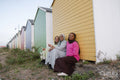 Muslim friend looking at camera while sitting by beach hut