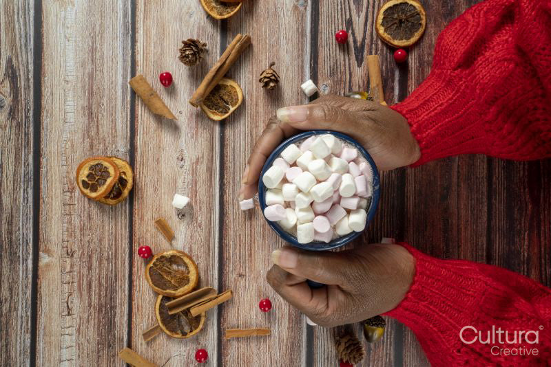 Woman holding mug with marshmallows