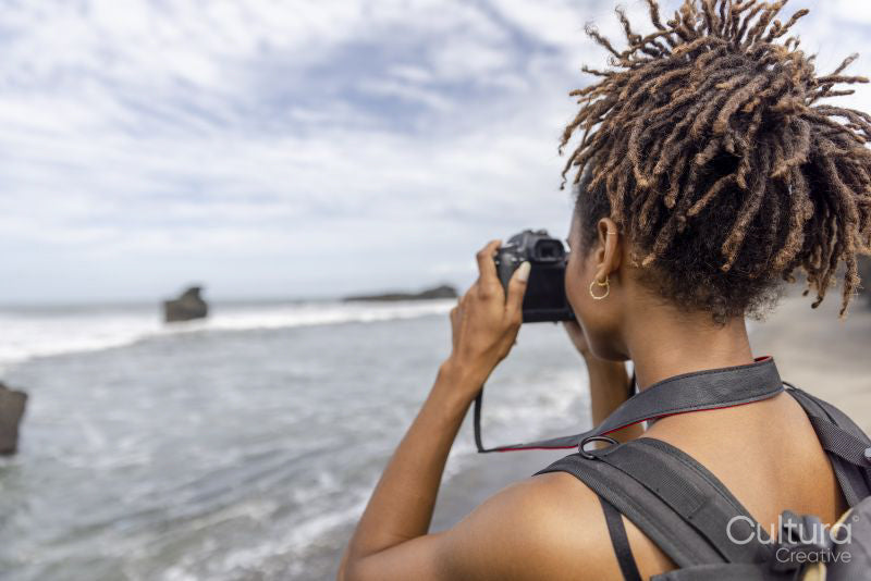 Indonesia, Bali, Female tourist photographing sea view