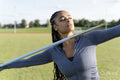 Portrait of female athlete throwing javelin