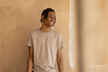 Smiling teenage boy at freshly painted wall in house