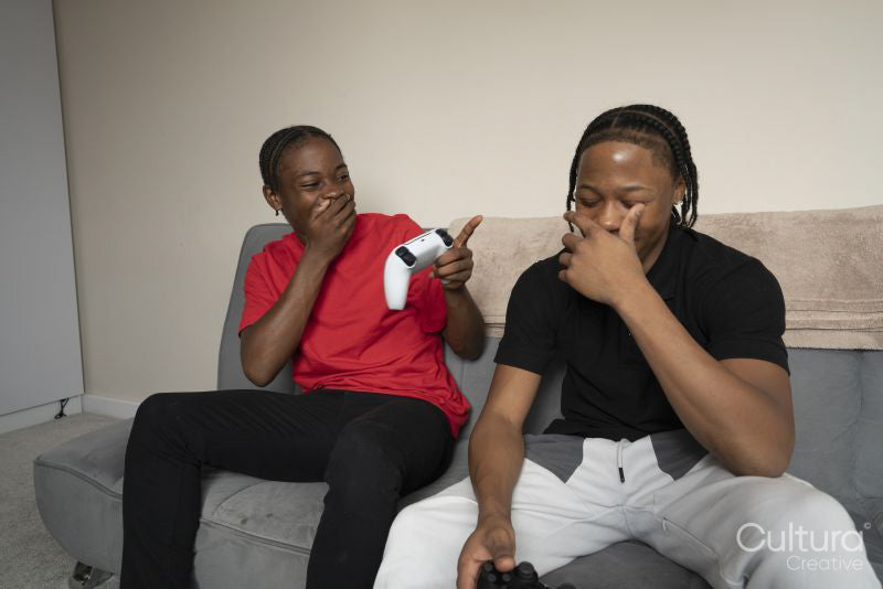Teenage friends playing video game at home