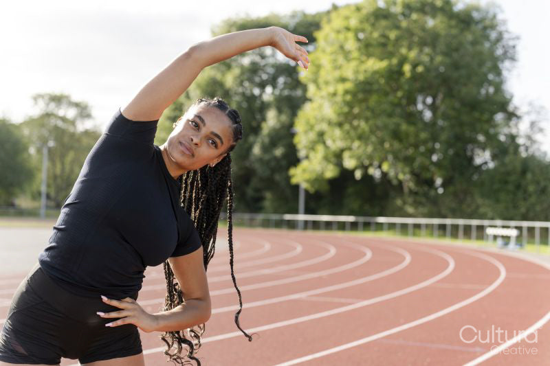 Female athlete exercising at sports track