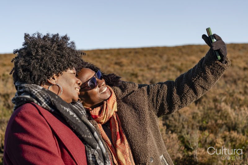 Two senior women taking selfie in landscape
