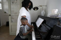 Mother and son playing piano
