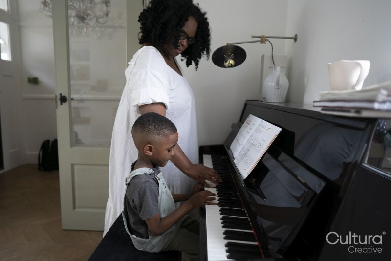 Mother and son playing piano