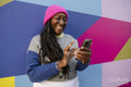 Beautiful woman using phone on colorful background