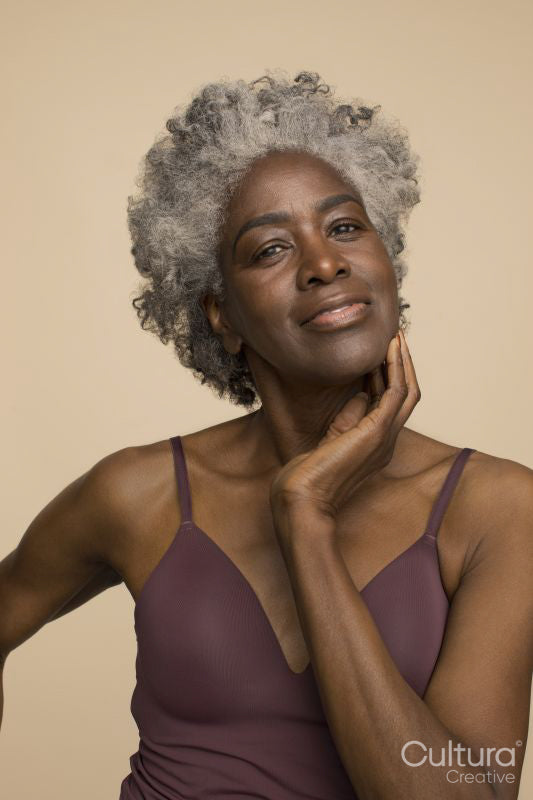 Studio portrait of smiling mature woman