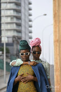 Fashion portrait of two women standing in urban street