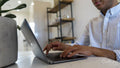 Man using laptop, close up of hands