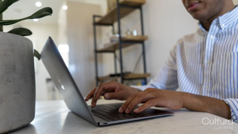 Man using laptop, close up of hands