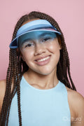 Studio portrait of smiling girl wearing sun visor