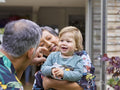 Grandparents playing with grandson outdoors