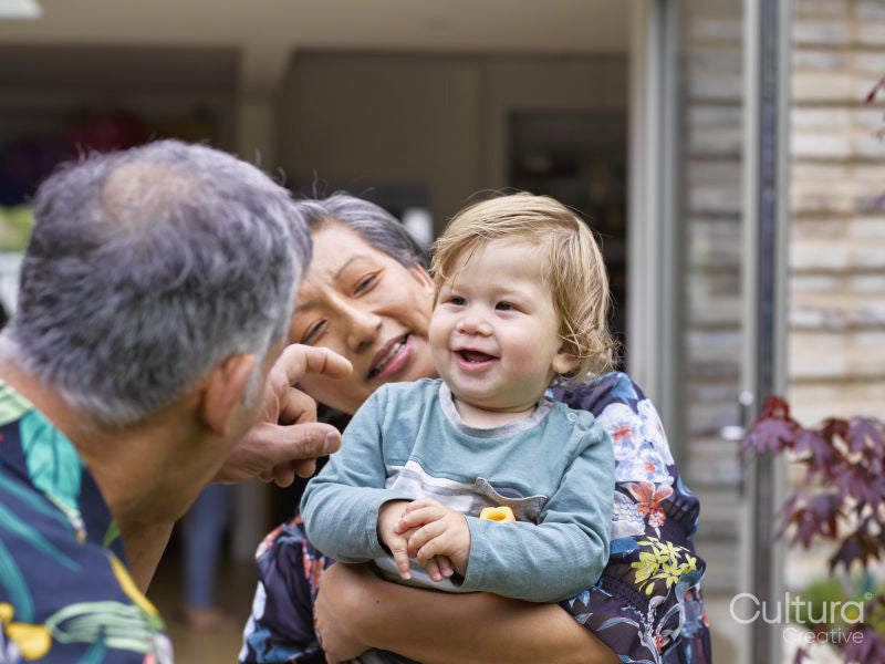 Grandparents playing with grandson outdoors