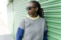 Young stylish woman leaning against green door