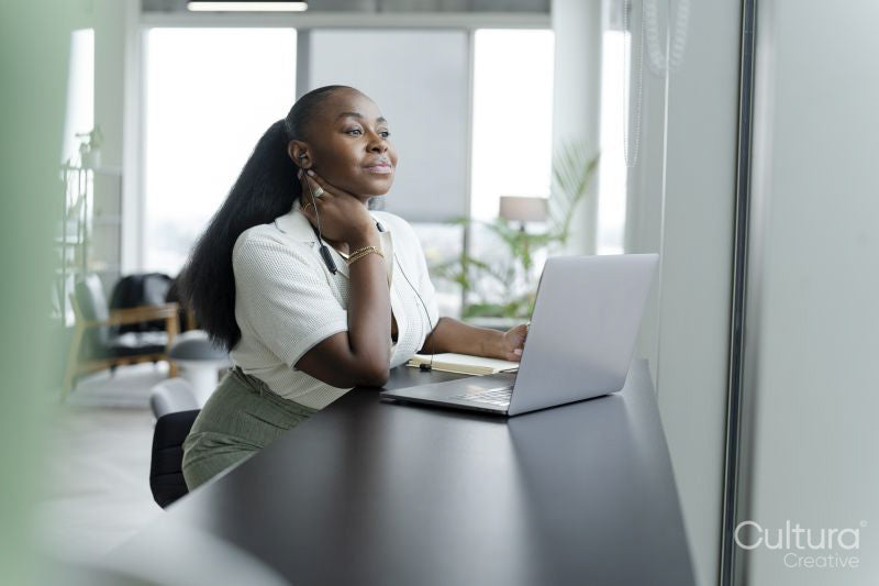 Businesswoman with laptop working in modern office