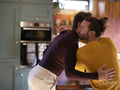 couple embracing in kitchen