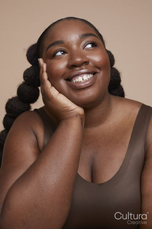 Studio shot of smiling young woman with braided hair