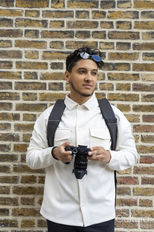 Portrait of young man holding camera