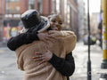 Two young women hugging in street