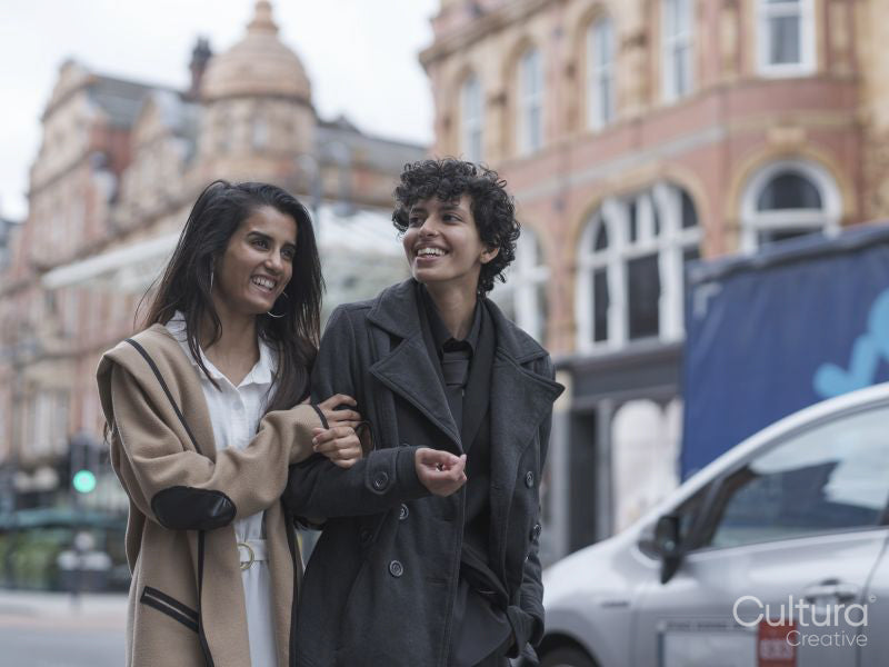 Female couple walking in street