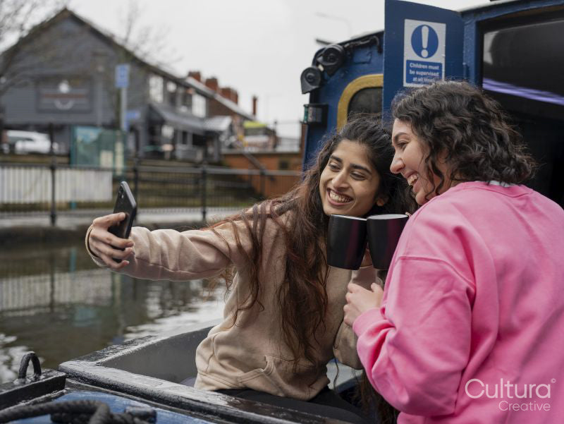 Cheerful women smiling to camera on boat