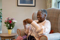 Smiling senior woman knitting in nursing home