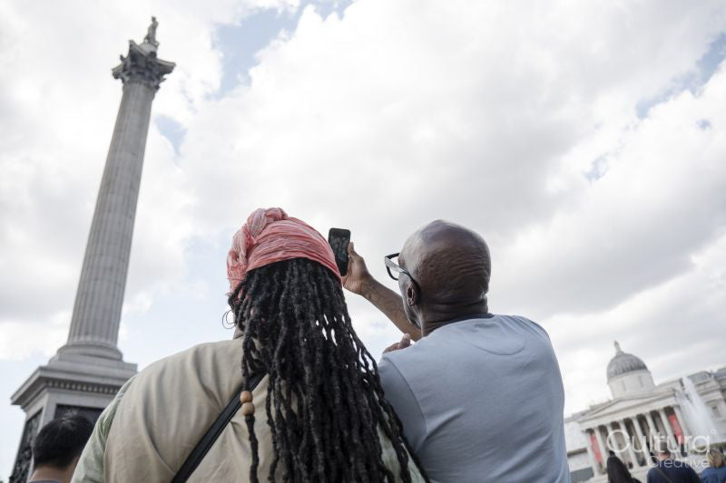 Happy mature couple photographing Nelson's Column while visiting city