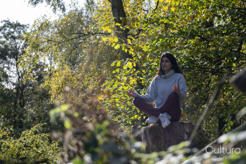 Woman meditating in forest