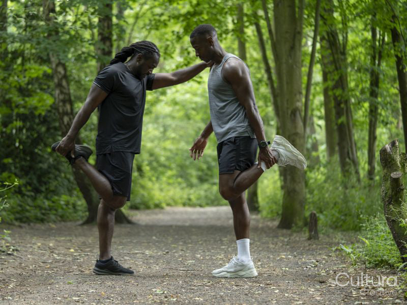 Two men stretching in forest