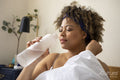 Woman drinking water in bed