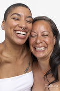 Studio portrait of women laughing with eyes closed