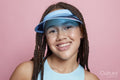 Studio portrait of smiling girl wearing sun visor