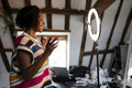 Smiling woman recording video at home