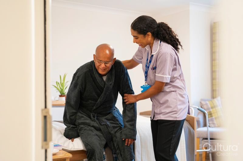 Nurse helping senior man in his room at nursing home