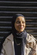 Portrait of young woman wearing hijab