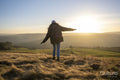 Female hiker walking in rural landscape
