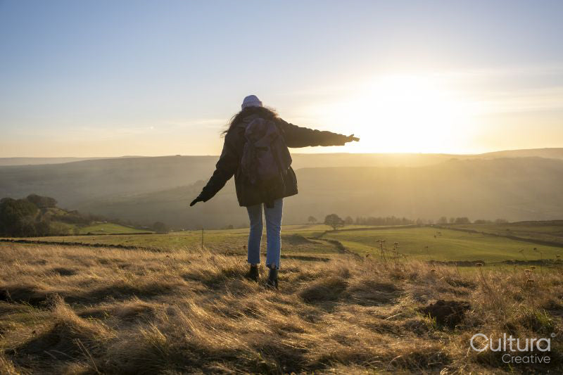 Female hiker walking in rural landscape